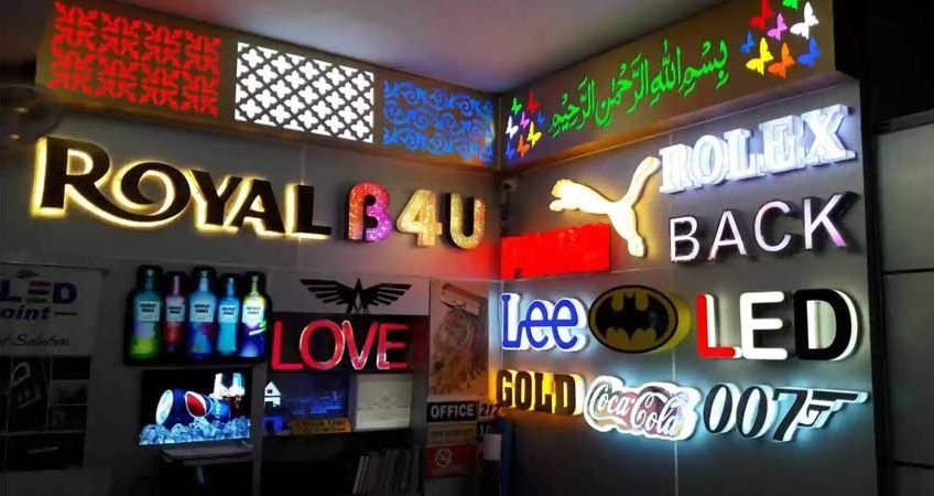 "Various illuminated signage boards including brand names like Rolex, Coca-Cola, Lee, and LED boards used for indoor and outdoor advertising and store branding".