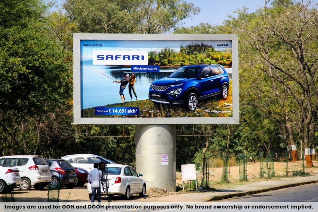 Tata Safari car advertisement displayed on large unipole billboard along roadside highway outdoor advertising location
