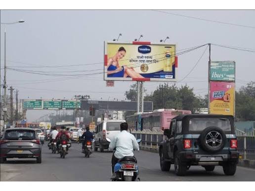 Large outdoor billboard showcasing Unipole Advertising Services on a major Indian road